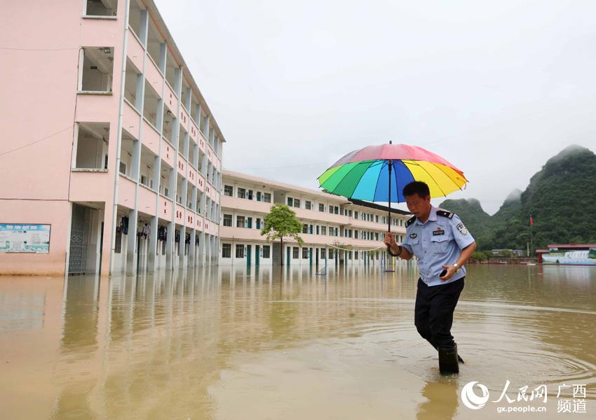 6月26日,在广西柳州市融安县泗顶镇中心小学校园,派出所民警钟居在