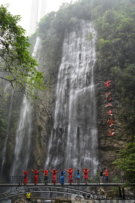 为喜迎新中国70华诞,古龙山大峡谷景区周边悬挂国旗,彩旗,工作人员给