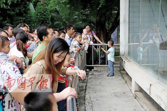 南宁人民公园内,孩子尿急,这名家长就直接在湖边给孩子把尿.