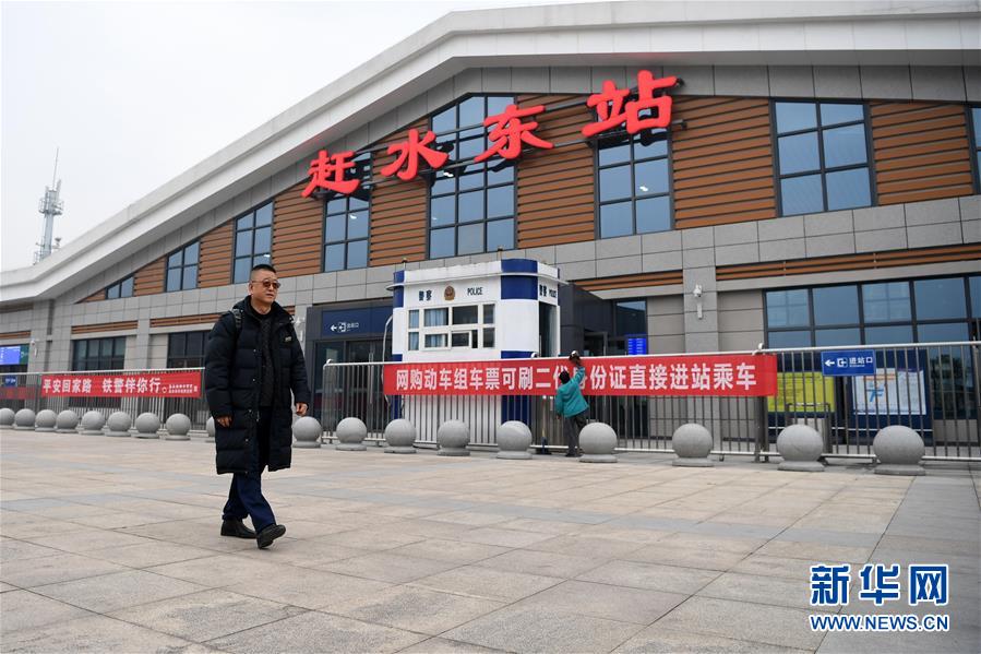 1月13日,张维华从赶水东站外走过.新华社记者 唐奕 摄
